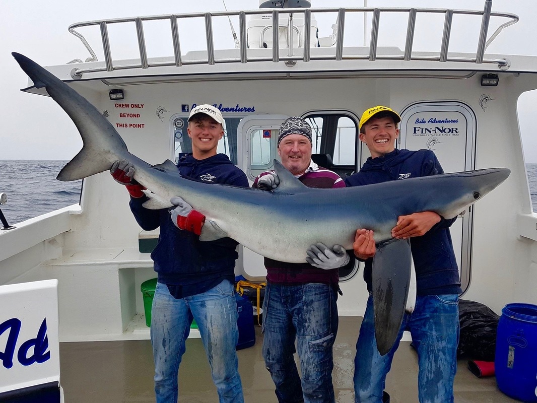 Liam with a stunning Blue Shark of 167lb caught on Bite Adventures